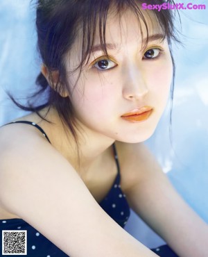 A woman in a polka dot dress posing for a magazine cover.