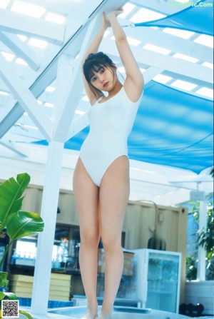 A woman in a straw hat is posing for a magazine.