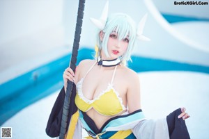 A woman dressed in a costume holding a sword.