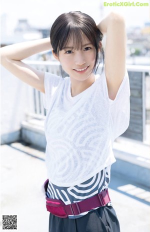 A woman in a purple shirt is posing for a magazine.