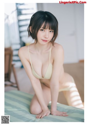 A woman in a bra top is posing for a magazine cover.