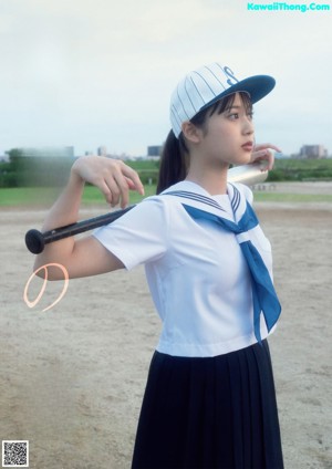 A woman in a blue dress holding a lollipop.
