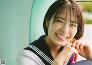 A woman in a school uniform holding a cup of ice cream.