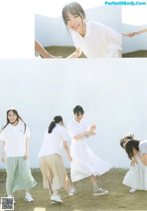 A group of young women laying on top of a bed.