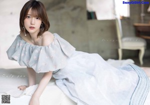 A magazine with a picture of a woman in a white dress.