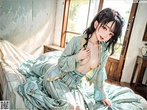 A woman in a blue robe sitting on a wooden bench.