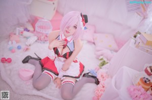 A woman in a maid outfit is posing for a picture.