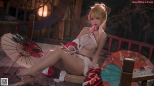 A woman in a red and white lingerie sitting on a wooden floor.