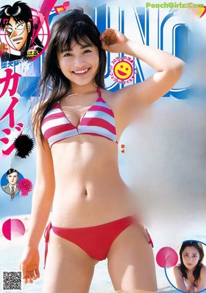 A woman in a blue bikini laying on the beach.