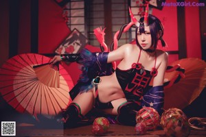 A woman in a costume with tentacles around her body.